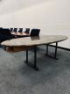 Pre-owned oval conference table has brown marble surface. With (2) copper dual post T-legs and (1) under surface (19